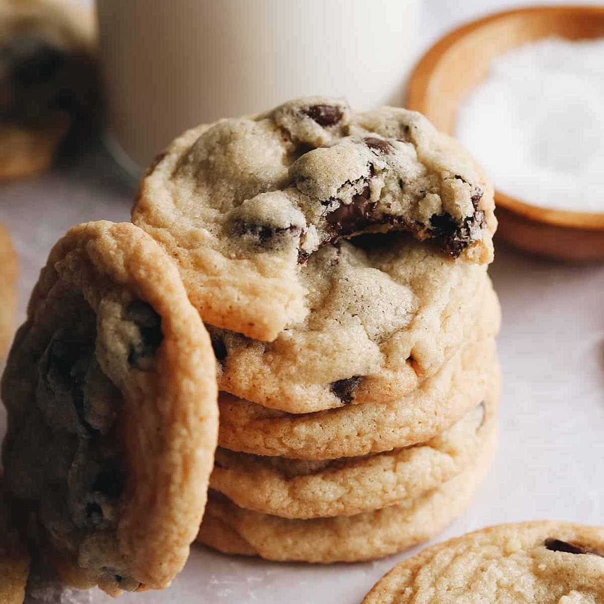• A perfect stack of golden brown gluten-free chocolate chip cookies fresh out of the oven.